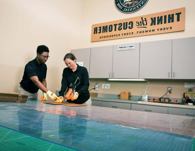 Two packaging designers in a packaging lab